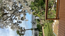 View from the back deck looking at the screen patio on the water's edge